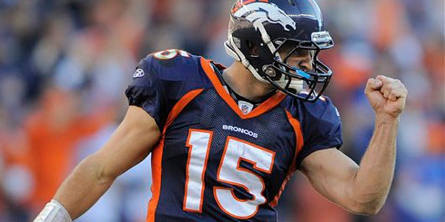 n this Dec. 18, 2011 file photo, Denver Broncos quarterback Tim Tebow (15) reacts after a touchdown run by Denver Broncos running back Lance Ball (35) against the New England Patriots, in Denver.