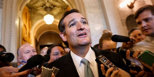 Sen. Ted Cruz talks to reporters as he emerges from the Senate Chamber on Capitol Hill in Washington, Wednesday, Sept 25, 2013.