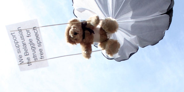In this undated photo provided by Studio Total teddy bears hang on parachutes during a training in Stockholm, Sweden.