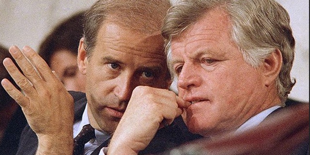 Kennedy, shown here conferring with future Vice President Joe Biden, painted a frightening picture of "Judge Bork's America."