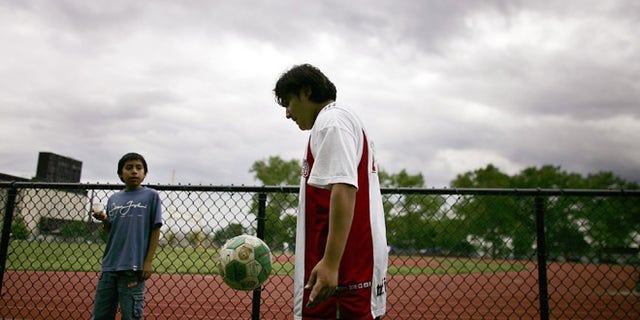 NEW YORK - JUNE 04: A teenager plays with a soccer ball June 4, 2006 in Brooklyn borough of New York City. While America has never been a powerhouse in the game of soccer, the world?s most popular sport, the upcoming World Cup in Germany is attracting significant attention on this side of the Atlantic. With an influx of Latino, African and other immigrants to the United States, soccer is gradually gaining in popularity to more traditional America sports such as football and baseball. (Photo by Spencer Platt/Getty Images)