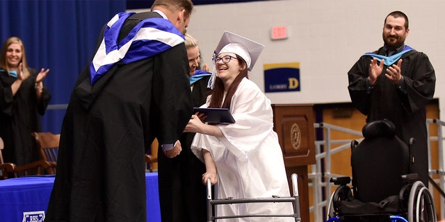 Lexi Wright left her chair and walked across the stage and down the ramp to accept her diploma at Ravenna High School's graduation on Wednesday, May 30, 2018, at Kent State University in Kent, Ohio, to a standing ovation. The Ohio teenager has cerebral palsy and was never expected to be able to walk has shocked her family by doing just that at her high school graduation.