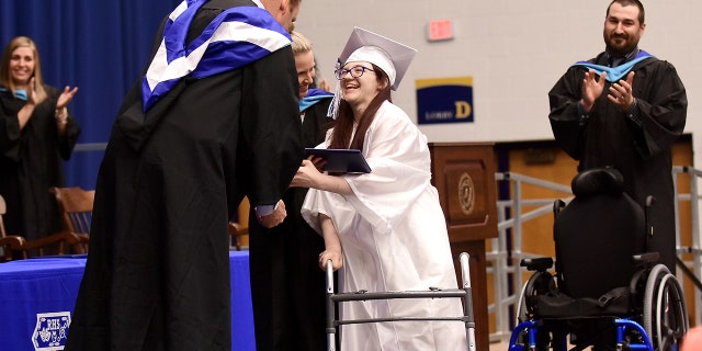 Lexi Wright left her chair and walked across the stage and down the ramp to accept her diploma at Ravenna High School's graduation on Wednesday, May 30, 2018, at Kent State University in Kent, Ohio, to a standing ovation. The Ohio teenager has cerebral palsy and was never expected to be able to walk has shocked her family by doing just that at her high school graduation.