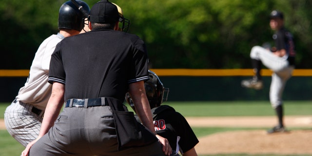 A batter about to hit a pitch during a baseball game.