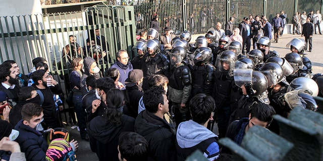 Dec. 30, 2017: In this photo taken by an individual not employed by the Associated Press and obtained by the AP outside Iran, anti-riot Iranian police prevent university students from joining other protesters in Tehran, Iran.