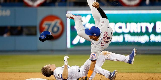 LOS ANGELES, CA - OCTOBER 10: Ruben Tejada #11 of the New York Mets is hit by a slide by Chase Utley #26 of the Los Angeles Dodgers in the seventh inning in an attempt to turn a double play in game two of the National League Division Series at Dodger Stadium on October 10, 2015 in Los Angeles, California. (Photo by Sean M. Haffey/Getty Images)