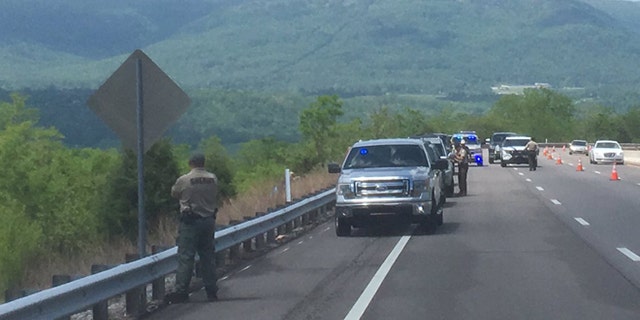 Tennessee sheriff deputies at the spot where a woman jogger's badly decomposed body was found.
