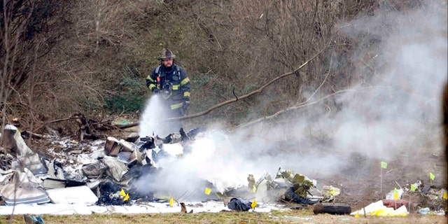 Feb. 4, 2014: A Nashville firefighter douses the wreckage from a plane crash that killed everyone on board outside the Bellevue YMCA in Nashville, Tenn.