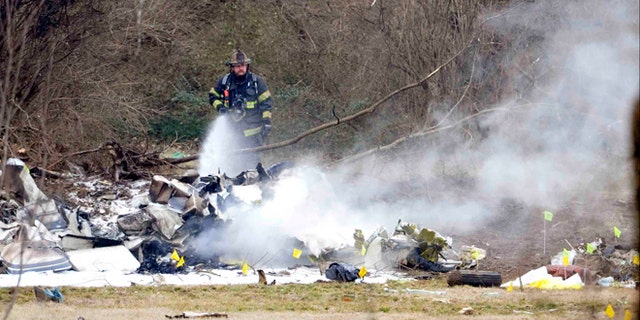 Feb. 4, 2014: A Nashville firefighter douses the wreckage from a plane crash that killed everyone on board outside the Bellevue YMCA in Nashville, Tenn.