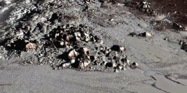 An image of the Tenzing Montes peaks on Pluto created with New Horizons data and released on July 10, 2018. The mountains range from about 1.8 miles to 3.7 miles (3 to 6 kilometers) above the dwarf planet's surface.