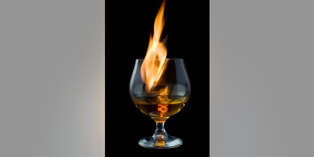 fire tongue inside glass, on black background