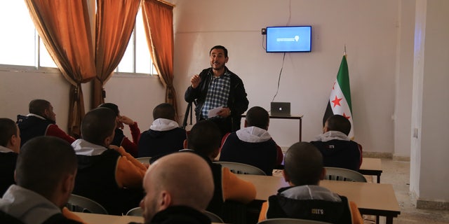 A leader instructs prisoners at the Syrian Center for Anti-Extremist Ideology