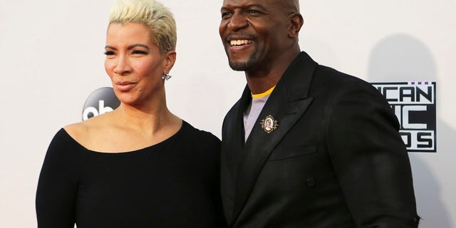 Actor Terry Crews and his wife, Rebecca King-Crews, arrive at the 2015 American Music Awards in Los Angeles, Nov. 22, 2015.