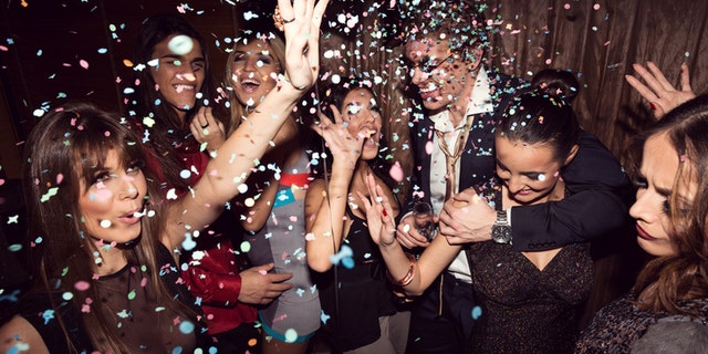 Group of friends dancing and enjoying a night out in the club.