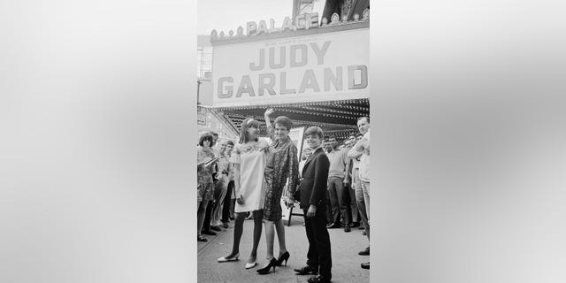 27 Jul 1967 --- Original caption: To the Palace. The famed singer Judy Garland stands with her children Lorna, 14, and Joey Luft, 12, outside The Palace Theatre in New York where she played two memorable earlier stands in 1951 and 1956. She's back for a return four-week engagement titled, At Home at The Palace, to be presented by her former husband Sid Luft. --- Image by © Bettmann/CORBIS