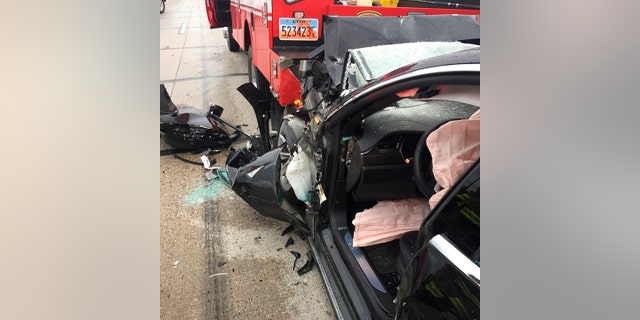 In this Friday, May 11, 2018, photo released by the South Jordan Police Department shows a traffic collision involving a Tesla Model S sedan with a Fire Department mechanic truck stopped at a red light in South Jordan, Utah. Witnesses indicated the Tesla Model S did not brake prior to impact. Police Sgt. Samuel Winkler said the car's air bags were activated and that the Tesla's 28-year-old driver suffered a broken right ankle, while the driver of the mechanic truck didn't require treatment. Police in a Salt Lake City suburb say it's not immediately known whether a Tesla Model S sedan's semi-autonomous Autopilot driving system was in use when it rear-ended a truck apparently without braking before impact at approximately 60 mph. (South Jordan Police Department via AP)
