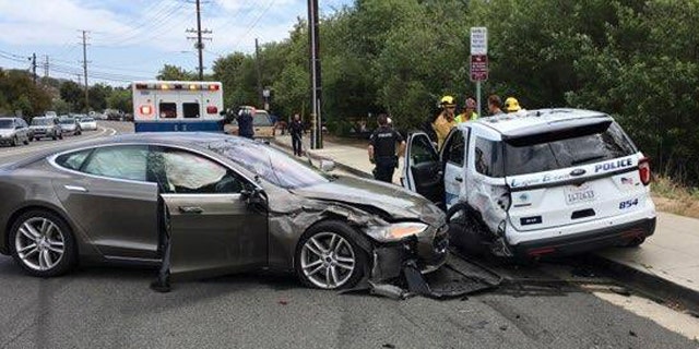 The cruiser was forced partially onto the sidewalk during the crash.