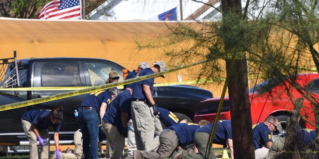 Federal officials investigate the scene of a church shooting in Sutherland Springs, Texas.