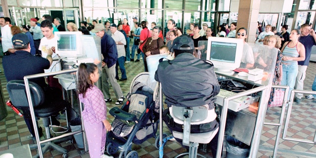 U.S. Customs Inspectors check identity papers at the Paso del Norte port of entry in El Paso, TX.