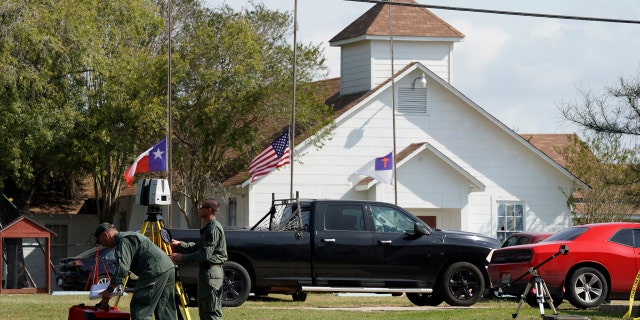 Officials with a scanner near the entrance of the site of the shooting at the First Baptist Church of Sutherland Springs, Texas.