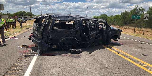 In this image tweeted by David Caltabiano of KABB/WOAI, a heavily damaged SUV is seen on Texas Highway 85 in Big Wells, Texas, after crashing while carrying more than a dozen people fleeing from Border Patrol agents.