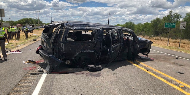 In this image tweeted by David Caltabiano of KABB/WOAI, a heavily damaged SUV is seen on Texas Highway 85 in Big Wells, Texas, after crashing while carrying more than a dozen people fleeing from Border Patrol agents.