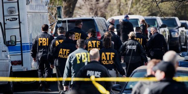 ATF agents descend on the site of one of the Austin package explosions on Monday.