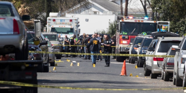 Authorities investigate an explosion at a home in Austin, Texas, Monday, March 12, 2018.
