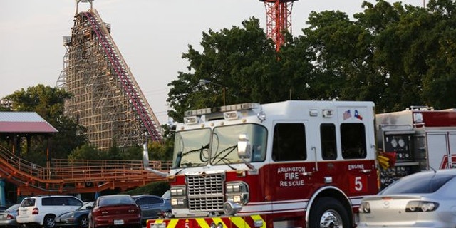 July 19, 2013: Emergency personnel are on the scene at Six Flags Over Texas in Arlington, Texas, after a woman died on the Texas Giant roller coaster.