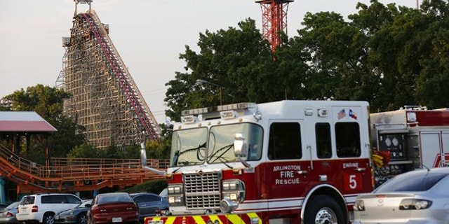 July 19, 2013: Emergency personnel are on the scene at Six Flags Over Texas in Arlington, Texas, after a woman died on the Texas Giant roller coaster.