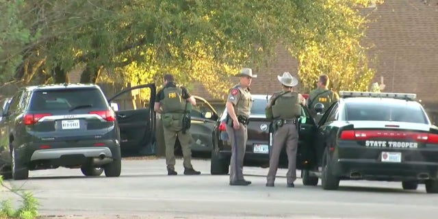 Authorities investigate the home of the suspected Austin serial bomber in Pflugerville, Texas.