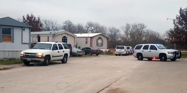 Authorities respond to a mobile home park in Schertz, Texas where a female suspect and a 7-year-old boy were killed in a gun battle.