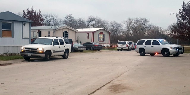 Authorities respond to a mobile home park in Schertz, Texas where a female suspect and a 7-year-old boy were killed in a gun battle.