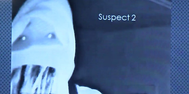 A second suspect in the violent home invasion can be seen on a surveillance camera.