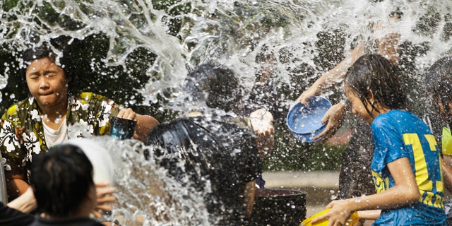 April 15: Thais splash water each other during New Year celebrations in Bangkok, Thailand. (AP)