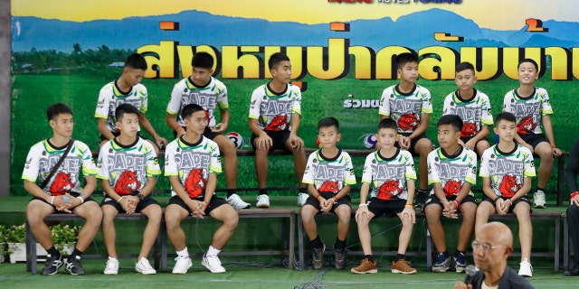 Members of the rescued soccer team and their coach sit during a press conference discussing their ordeal in the cave in Chiang Rai, northern Thailand, Wednesday, July 18, 2018