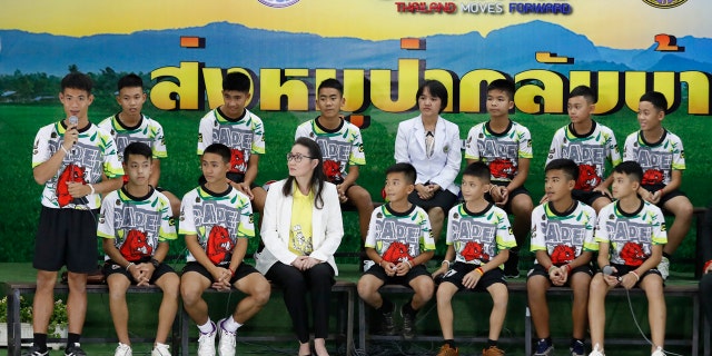 Coach" Ake" Ekkapol Janthawong, left, speaks on behalf of the 12 boys and himself and their cave rescue during a press conference discussing their ordeal.