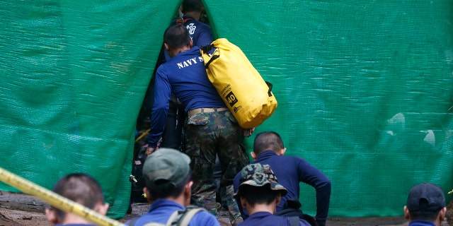 Rescuers arrive near a cave where 12 boys and their soccer coach have been trapped since June 23, in Mae Sai, Chiang Rai province, in northern Thailand, July 8, 2018.