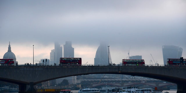 City workers cross the River Thames with the City of London financial district seen behind in London, in Britain October 27, 2016. REUTERS/Toby Melville - RTX2QO8P
