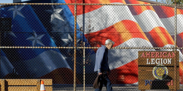 A man walks outside of the American Legion Hall, which served a free Thanksgiving dinner, in Antioch, Calif., Tuesday, Nov. 29, 2016. San Francisco Bay Area health officials were trying to determine if three people who died and five who were sickened after eating the Thanksgiving dinner at the church event held at American Legion Hall got sick there or at the assisted living facility where they all lived. (AP Photo/Jeff Chiu)