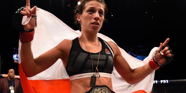 LAS VEGAS, NV - JULY 08: Joanna Jedrzejczyk of Poland celebrates after her decision victory over Claudia Gadelha of Brazil in their women's strawweight championship bout during The Ultimate Fighter Finale event at MGM Grand Garden Arena on July 8, 2016 in Las Vegas, Nevada. (Photo by Jeff Bottari/Zuffa LLC/Zuffa LLC via Getty Images)