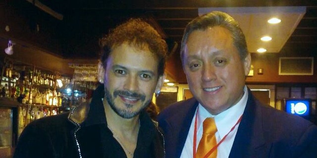 In this March 13, 2016 photo released by Miguel Angel Sanchez on June 19, 2016, Sanchez, right, stands with Mexican singer Alejandro "Jano" Fuentes in a restaurat in Chicago. Fuentes, who appeared on the Mexican version of "The Voice" in 2011 was shot and critically wounded on June 18 in an ambush shortly after celebrating his birthday with friends in Chicago. (Miguel Angel Sanchez via AP)