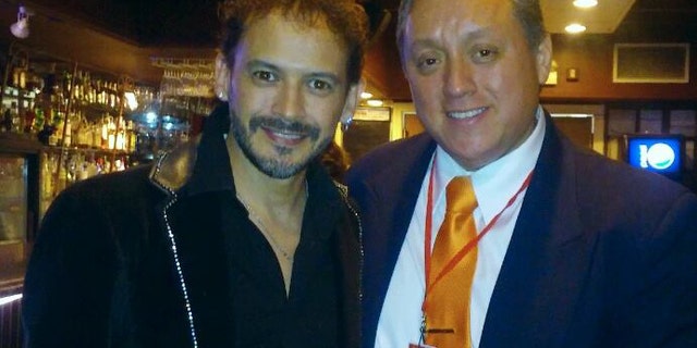In this March 13, 2016 photo released by Miguel Angel Sanchez on June 19, 2016, Sanchez, right, stands with Mexican singer Alejandro "Jano" Fuentes in a restaurat in Chicago. Fuentes, who appeared on the Mexican version of "The Voice" in 2011 was shot and critically wounded on June 18 in an ambush shortly after celebrating his birthday with friends in Chicago. (Miguel Angel Sanchez via AP)