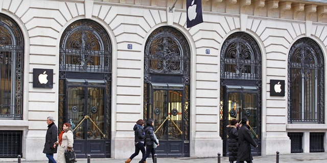 Jan. 1, 2013: Parisians and tourists wander in front of the Apple store located near the Paris Opera. A robbery took place at the flagship store on Monday, a few hours after the close of business.
