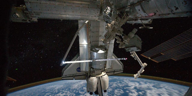 This view of the space shuttle Atlantis while still docked with the International Space Station was taken by a crew member aboard the station on the final day of joint activities between the crew members for the STS-135 and Expedition 28 missions.