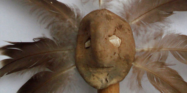 The clay effigy head measures just 1.5 by 1.1 inches (37 by 27 mm), with eyes made out of shell. Archaeologists placed modern feathers into the holes around the face to reveal what they would've looked like in antiquity.