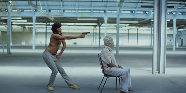 Childish Gambino shoots a man in his music video for "This Is America."