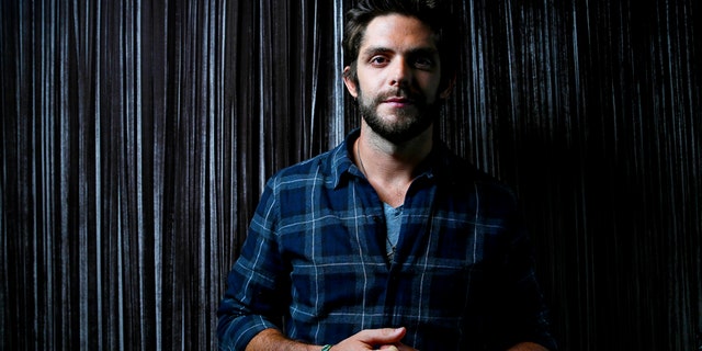 In this Sept. 15, 2015 file photo, country singer Thomas Rhett poses for a photo at Sinema Restaurant & Bar in Nashville, Tenn.