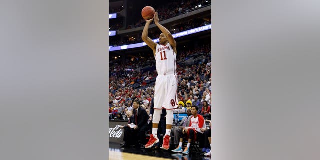 March 22, 2015: Oklahoma's Isaiah Cousins shoots a 3-point shot against Dayton in the first half of an NCAA tournament college basketball game in the Round of 32 in Columbus, Ohio.