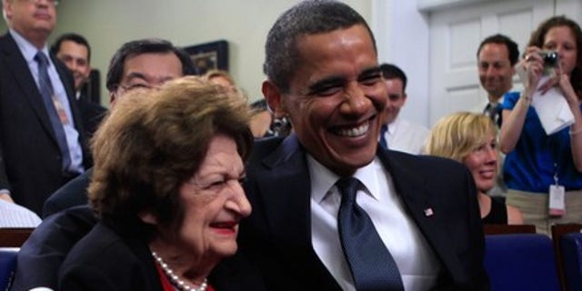 Aug. 4, 2009: President Obama mugs for the camera with Hearst White House columnist Helen Thomas during a mutual birthday celebration in the White House briefing room. (Reuters)
